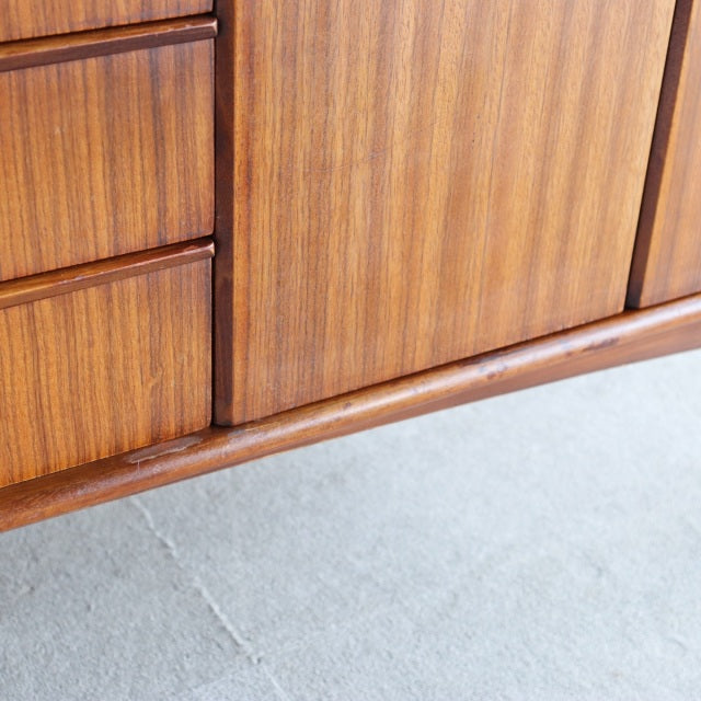 Vintage teak British mid-century sideboard by Elliotts of Newbury with smooth wood grain and rounded edges.