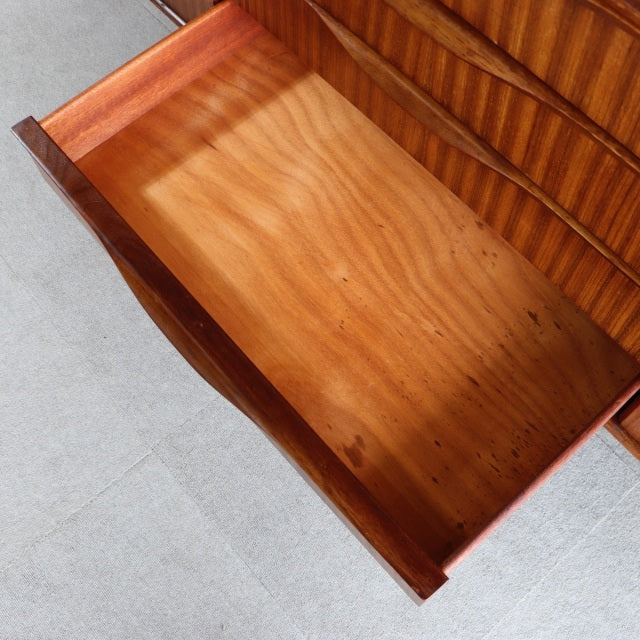 Vintage teak mid-century sideboard drawer by Elliotts of Newbury, showing smooth wood grain and curved front panel.