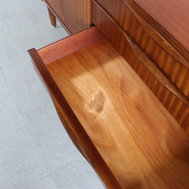 Vintage British mid-century teak sideboard drawer with smooth grain and clean-lined edges.