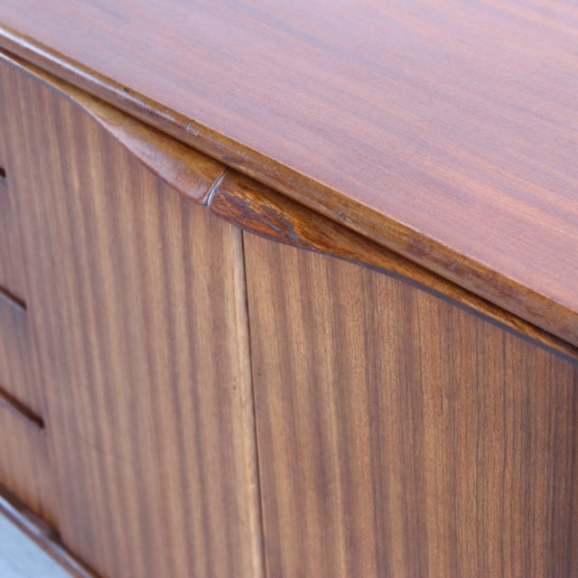 Vintage British mid-century teak sideboard by Elliotts of Newbury with rich wood grain and sculpted handles.