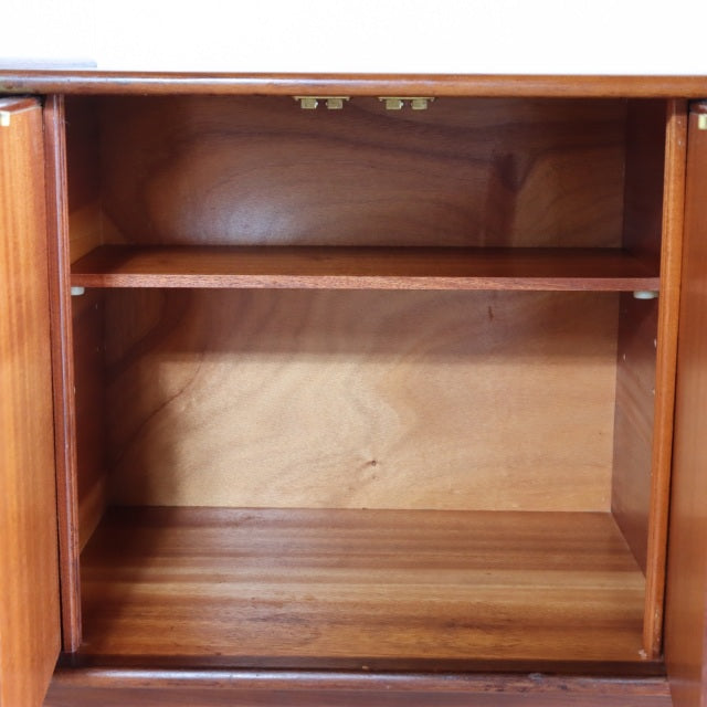 Open mid-century British teak sideboard by Elliotts of Newbury with visible wood grain and interior shelf.