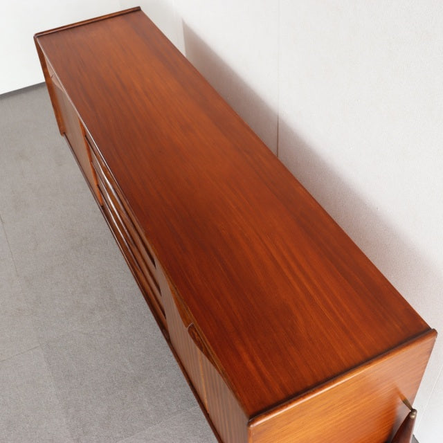 Mid-century British teak sideboard by Elliotts of Newbury with rich wood grain and sleek rectangular form.