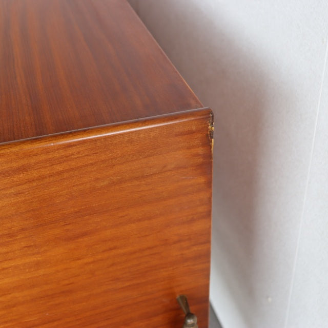 Close-up of vintage teak sideboard corner showing smooth wood grain and warm mid-century finish by Elliotts of Newbury.