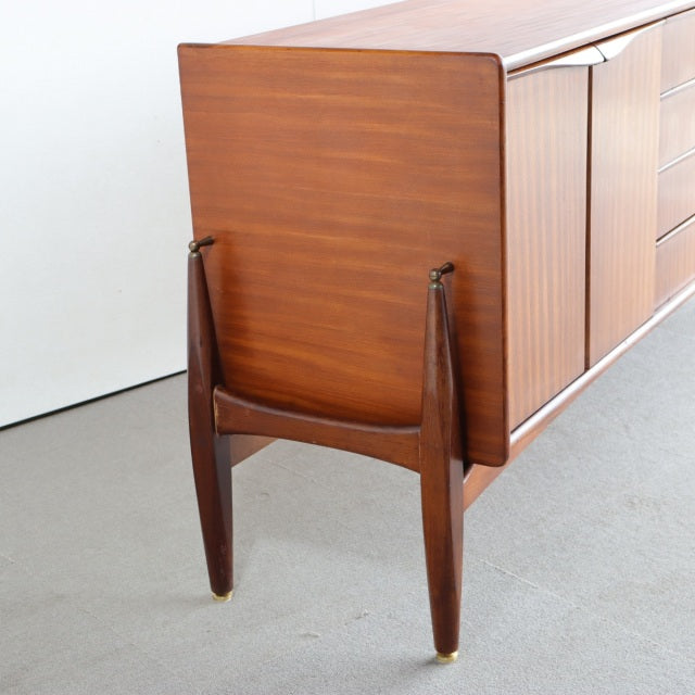 Vintage teak British mid-century sideboard by Elliotts of Newbury with tapered legs and rich wood grain.
