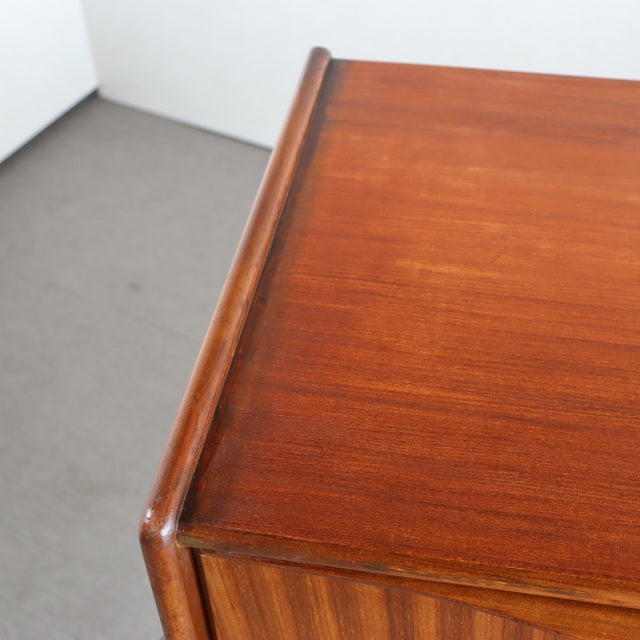 Vintage teak sideboard corner with smooth rounded edges and rich wood grain, mid-century British design by Elliotts of.