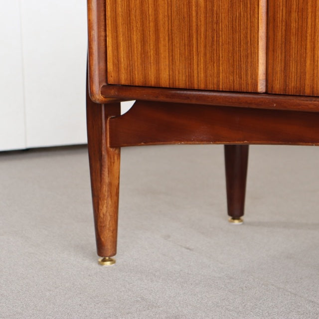 Close-up of mid-century British vintage teak sideboard leg by Elliotts of Newbury with brass-capped tapered wood detailing.