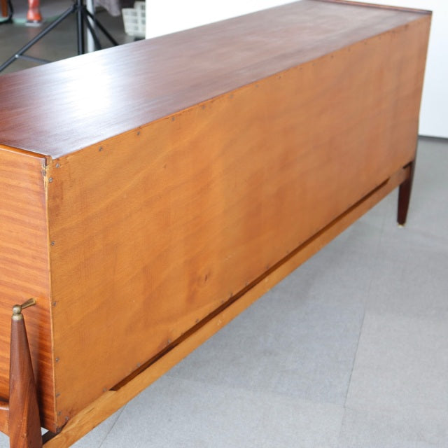 Vintage teak sideboard by Elliotts of Newbury, British mid-century design with clean lines and tapered legs, rich wood grain .