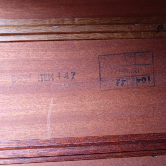 Close-up of vintage British mid-century teak sideboard underside with stamped branding and item number 147.