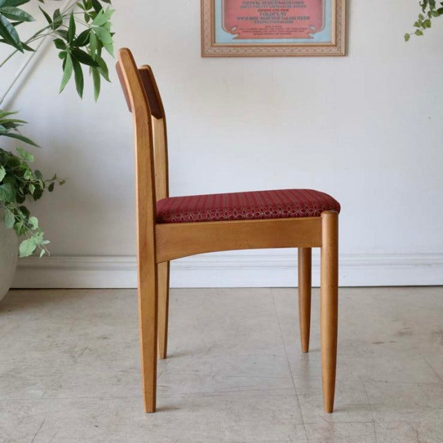 Mid-century British vintage teak dining chair with clean lines and red floral upholstered seat from Denmark.