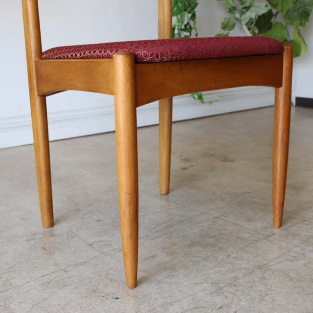 Mid-century British vintage teak dining chair with tapered legs and deep red floral upholstered seat.