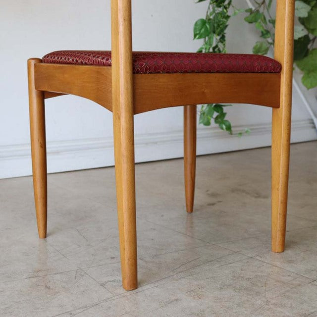 Mid-century British vintage teak dining chair with slender tapered legs and red floral upholstered seat from Denmark.
