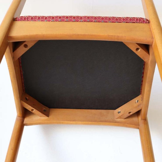 Vintage teak dining chair bottom view showing solid wood frame and flower-patterned upholstered seat, British mid-century.
