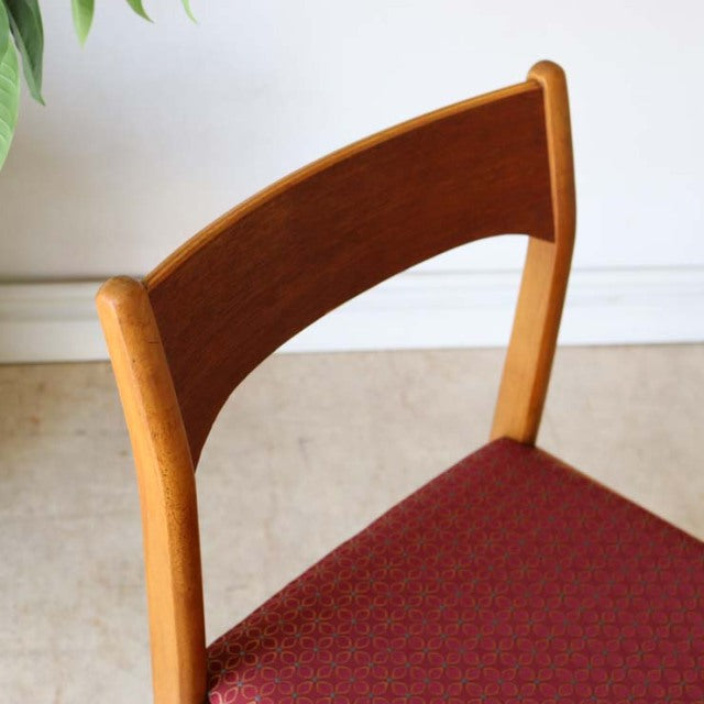 Vintage teak dining chair with curved British mid-century backrest and patterned red fabric seat from Denmark.