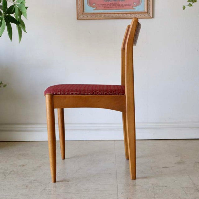 Mid-century British vintage teak dining chair from Denmark with slender legs and red floral upholstered seat.