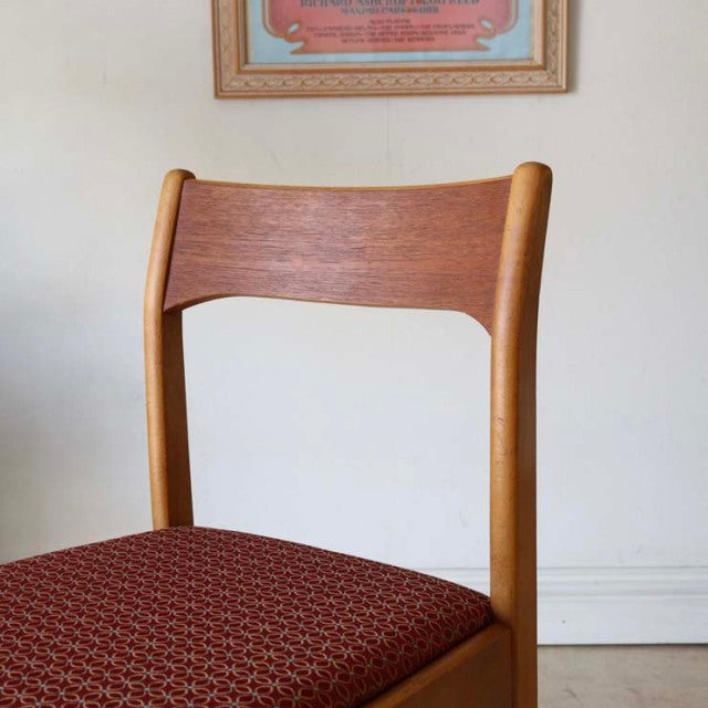 Vintage British mid-century teak dining chair with curved backrest and red patterned fabric seat from Denmark.
