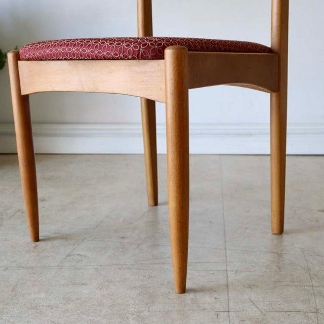 Vintage teak dining chair with tapered legs and mid-century British design, upholstered in red floral fabric from Denmark.