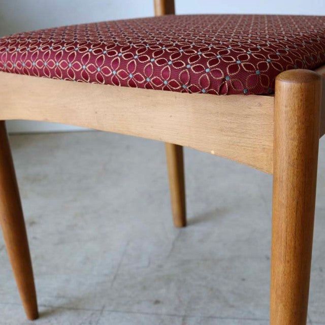 Mid-century British vintage teak dining chair with smooth wood grain and red patterned flower fabric seat, Denmark style.