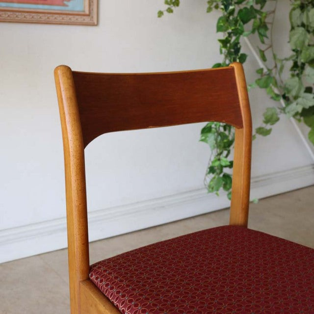 Vintage mid-century teak dining chair from Denmark with curved backrest and red patterned flower seat upholstery.