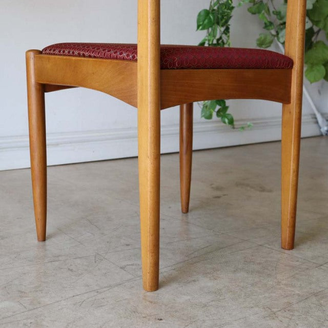 Mid-century vintage teak dining chair with tapered legs and red floral upholstered seat, British-Denmark style.