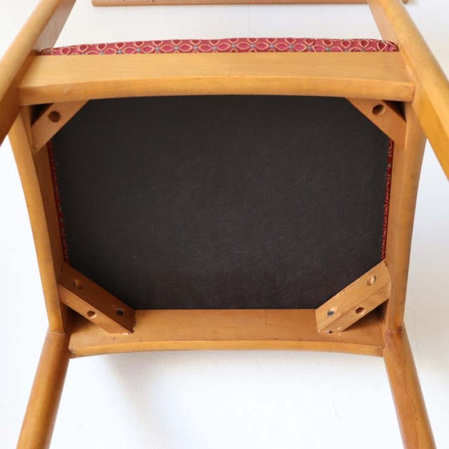 Underside view of vintage teak dining chair showing sturdy wooden frame, corner brackets, and smooth grain finish from.