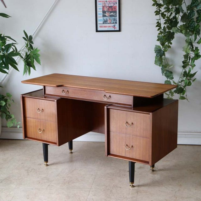 Vintage teak G-Plan mid-century desk with clean lines, tapered legs with brass tips, and rich wood grain.