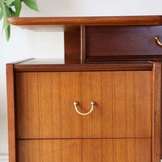Mid-century British G-PLAN teak desk with rich wood grain, brass handle, and sleek legs, vintage Denmark design.