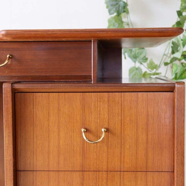 Vintage teak G-Plan mid-century desk with brass handles, smooth wood grain, and clean Danish-inspired lines.