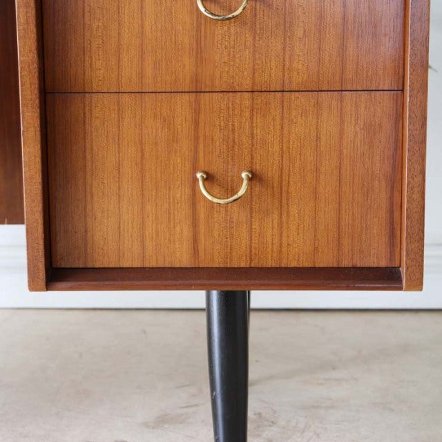 Vintage teak G-Plan mid-century desk drawer with brass handles and black tapered legs.