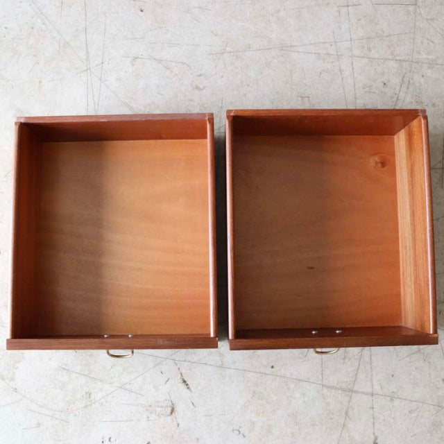 Pair of vintage teak drawers with brass handles, showcasing smooth wood grain and clean mid-century British design details.