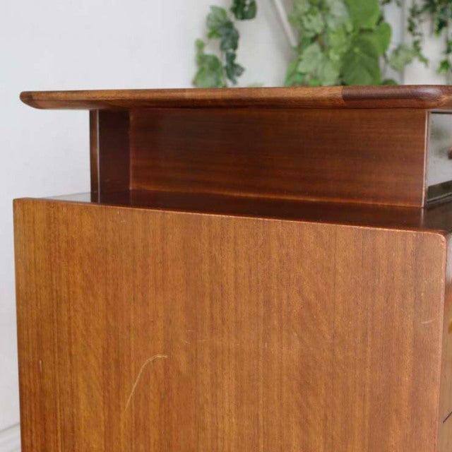 Vintage teak G-Plan mid-century British desk with smooth wood grain, rounded edges, and clean lines.