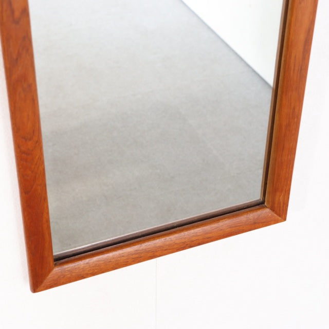 Rectangular vintage teak wall mirror with clean mid-century British design and warm wood grain finish.