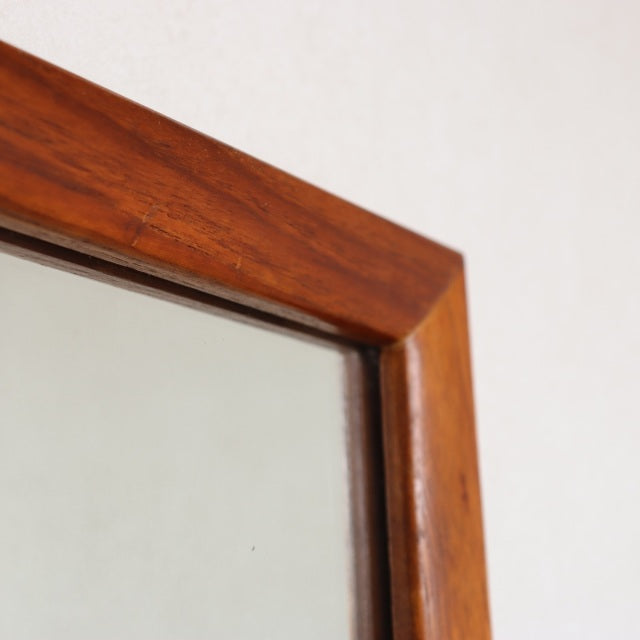Mid-century vintage teak mirror with rich wood grain and clean British-Danish design, rectangular frame close-up.
