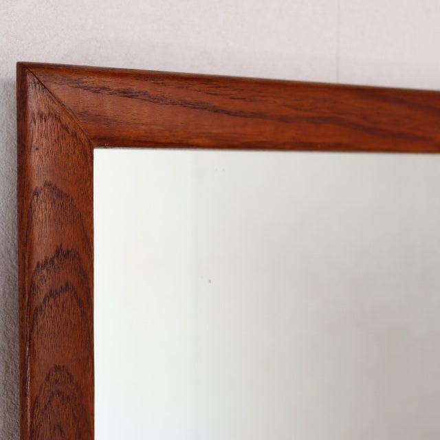 Vintage mid-century British teak wall mirror with rich wood grain and clean rectangular frame.