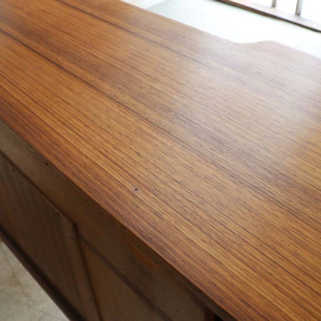 Vintage G-Plan teak desk top showcasing smooth wood grain and mid-century British design.
