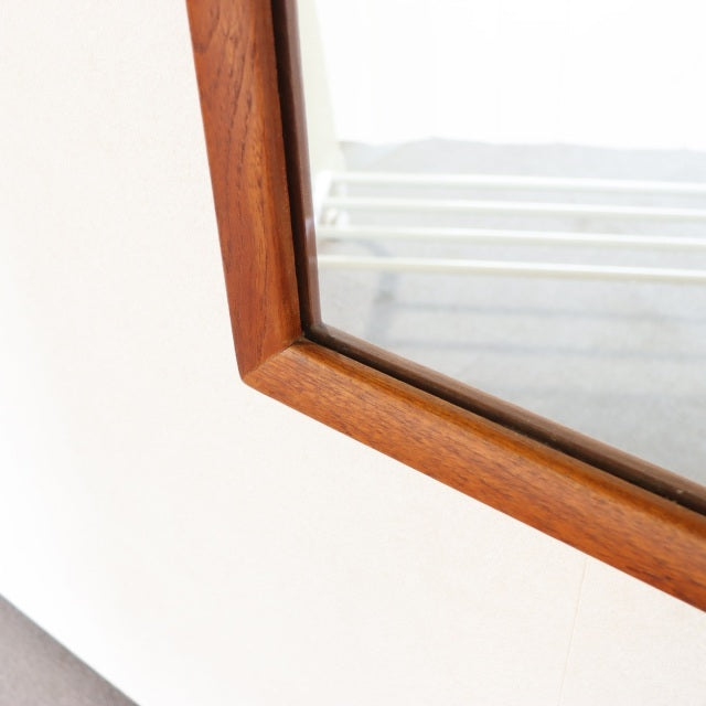 Vintage mid-century rectangular teak wall mirror with clean British-Denmark design and warm wood grain finish.