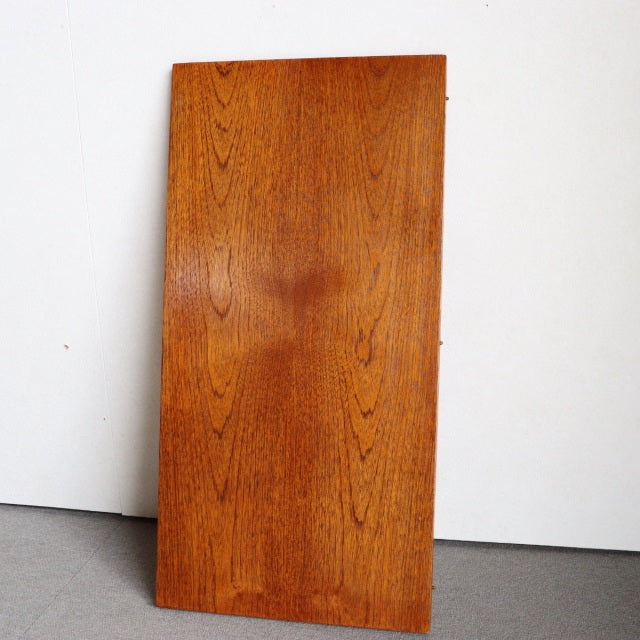 Vintage teak dining table top with rich wood grain, mid-century British and Danish design influences, smooth rectangular.