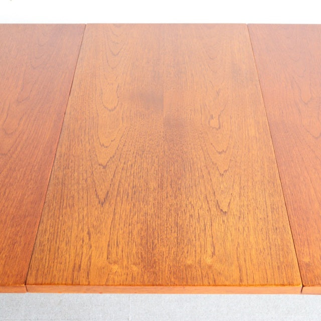 Mid-century British vintage teak dining table top with rich wood grain and warm honey tones.