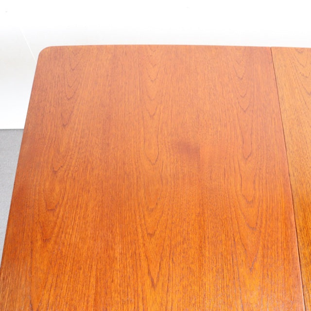 Vintage mid-century British teak dining table top showing rich wood grain and smooth finish with straight edges.