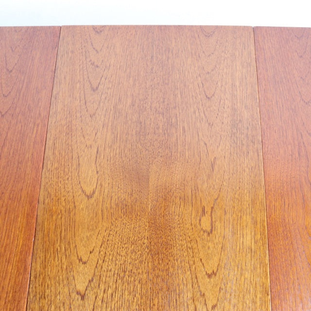 Vintage British mid-century teak dining table with rich wood grain and rectangular top.