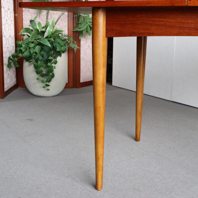 Mid-century teak dining table leg with fine wood grain and slender tapered design, British-Denmark vintage style.