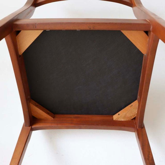 Underside view of vintage mid-century teak dining chair from Denmark with visible wood grain and sturdy frame.