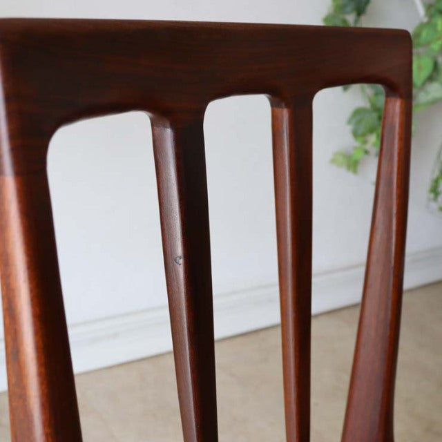 Close-up of vintage teak dining chair backrest with smooth grain and mid-century British design by A.Younger Ltd.
