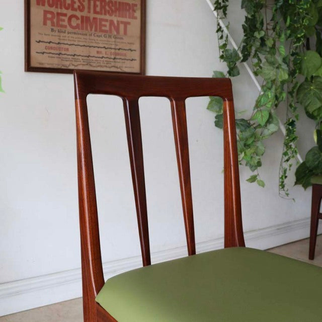 Mid-century British vintage teak dining chair by A.Younger Ltd with a slatted back and green upholstered seat.