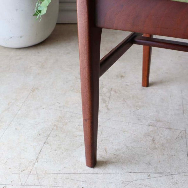 Mid-century teak dining chair leg with tapered British design and visible wood grain finish.