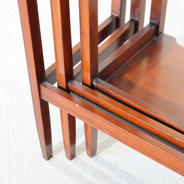 British mid-century vintage teak nest tables with rich wood grain, slender square legs, and smooth polished finish.