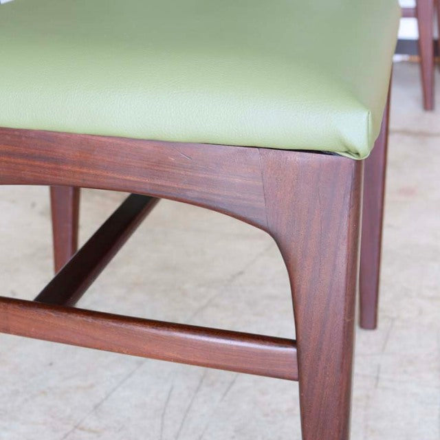 Mid-century British vintage teak dining chair by A.Younger Ltd., showcasing rich wood grain and green upholstered seat.