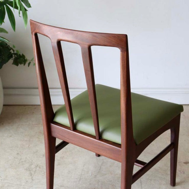 Set of four vintage teak dining chairs by A.Younger Ltd., featuring mid-century British design with open backrest slats and.