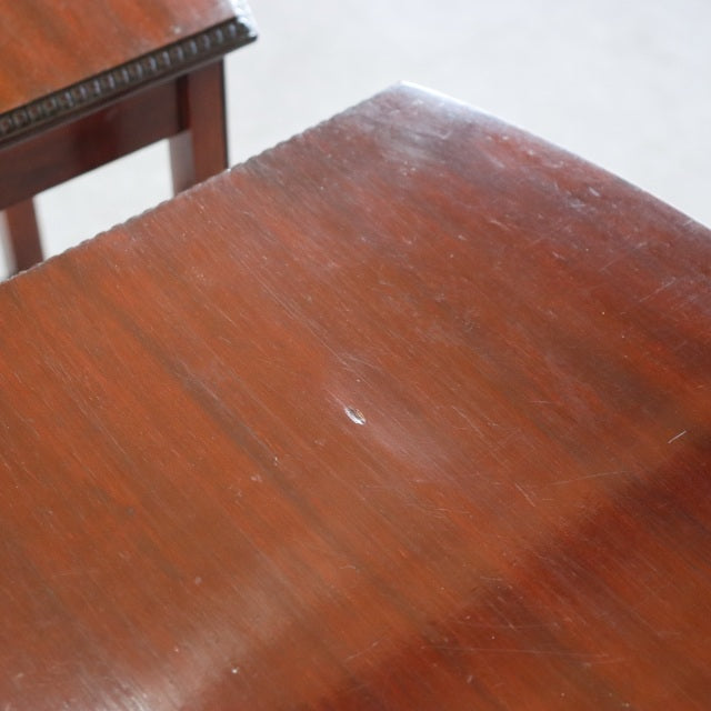 Close-up of vintage British teak nest table top showing rich wood grain and mid-century surface patina.