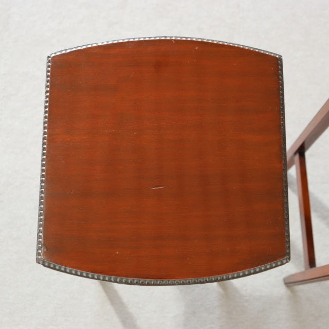 Vintage British mid-century teak nest table top with rich wood grain and decorative edge trim.