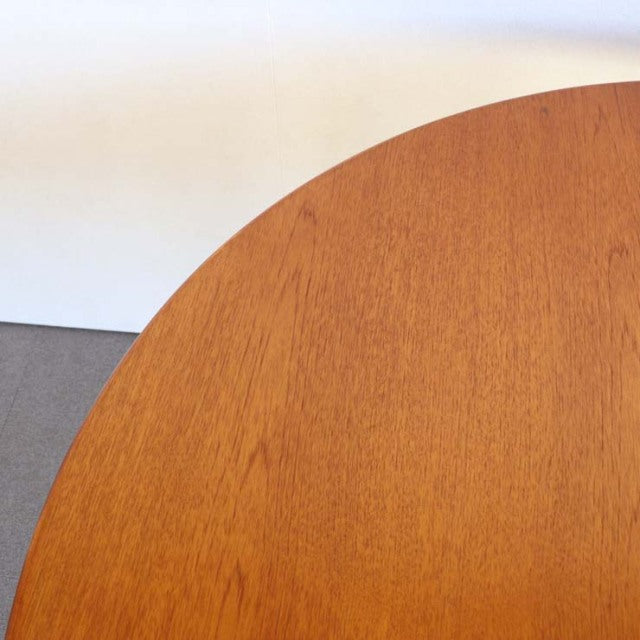 Round vintage teak dining table top with smooth wood grain, mid-century British design from Denmark.